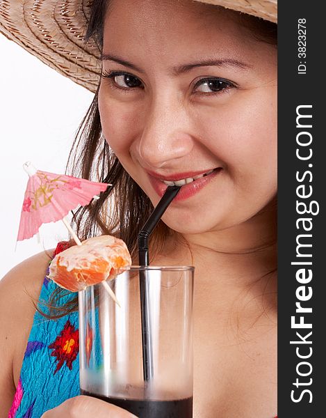 A woman wearing a summer clothing while sipping a cocktail drink
