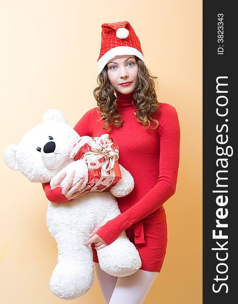 Beautiful young woman wearing santa hat with gifts. Beautiful young woman wearing santa hat with gifts