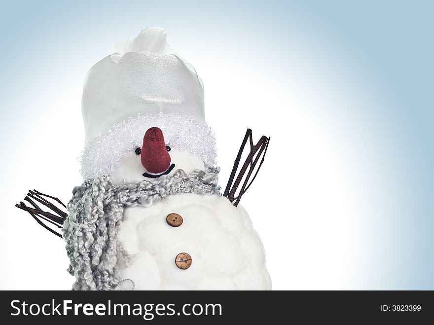 Small, funny snowman smiling over blue background