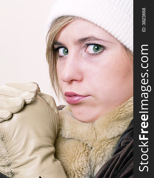 Closeup of young beautiful girl, wearing wool winter hat and scarf