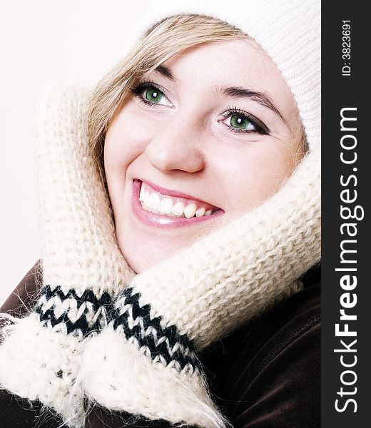 Closeup of young beautiful girl, wearing wool winter hat and gloves