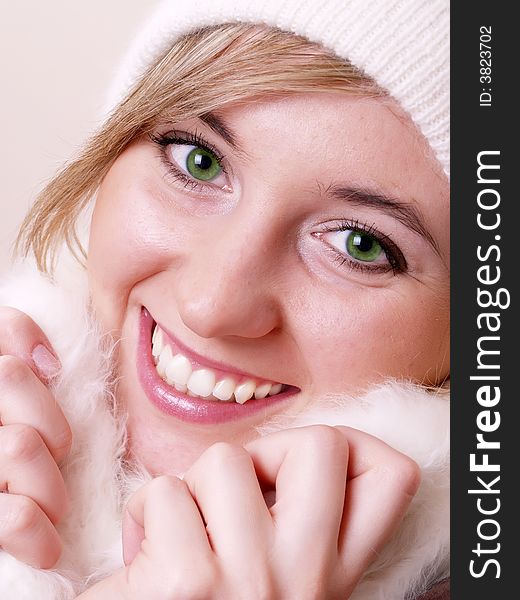 Closeup of young beautiful girl, wearing wool winter hat and scarf