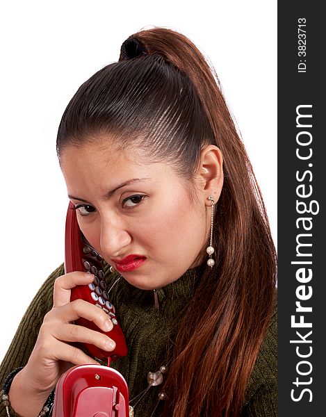 A young female talking on the phone looking unhappy. A young female talking on the phone looking unhappy