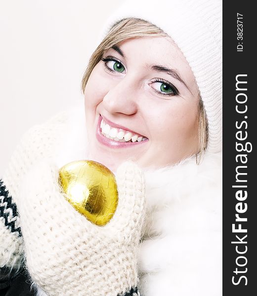 Closeup of young beautiful girl, wearing wool winter hat and scarf