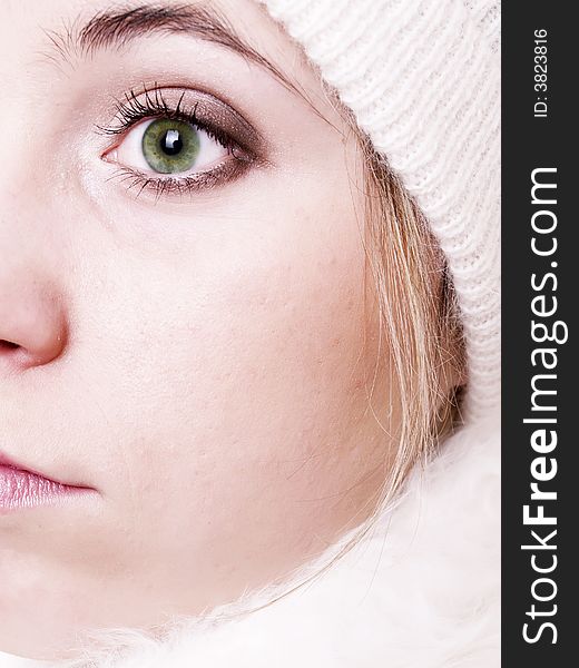 Closeup of young beautiful girl, wearing wool winter hat and scarf