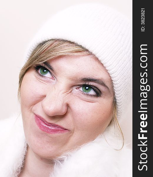 Closeup of young displeased girl, wearing wool winter hat and scar