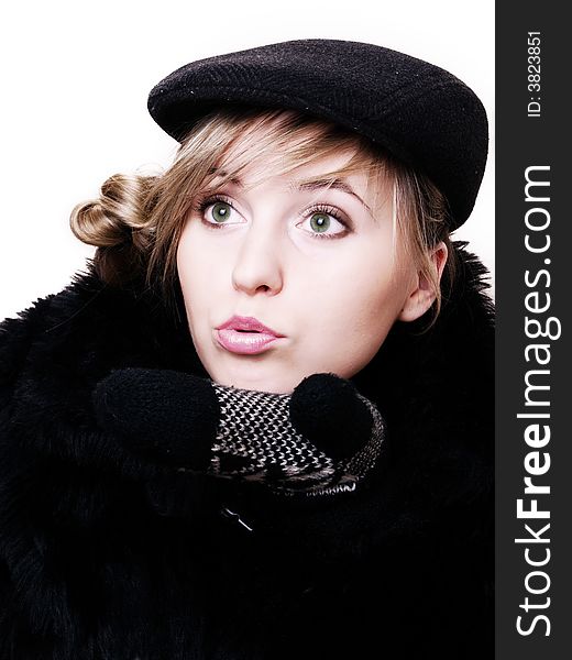 Closeup of young beautiful girl, wearing sheepskin coat, blowing a kiss