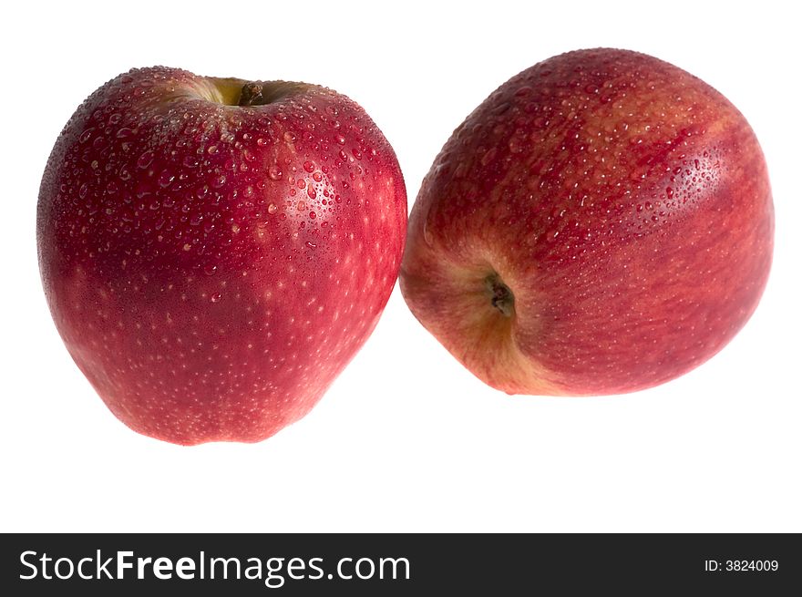 Two red apples with drops isolated