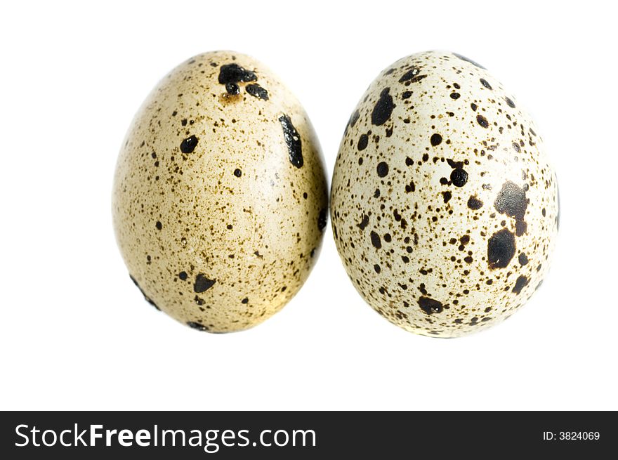 Two quail eggs isolated on white