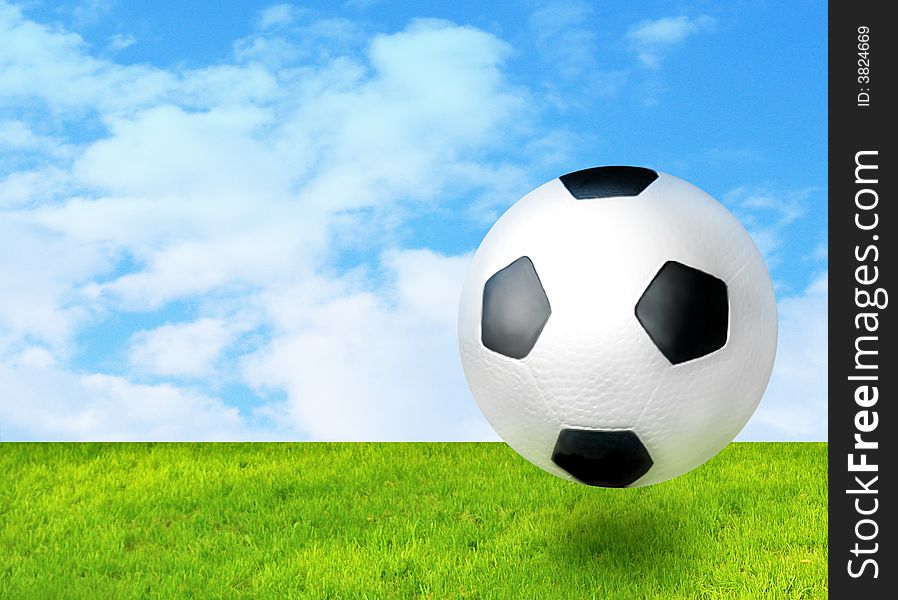 Football ball beween green grass and blue sky. Football ball beween green grass and blue sky