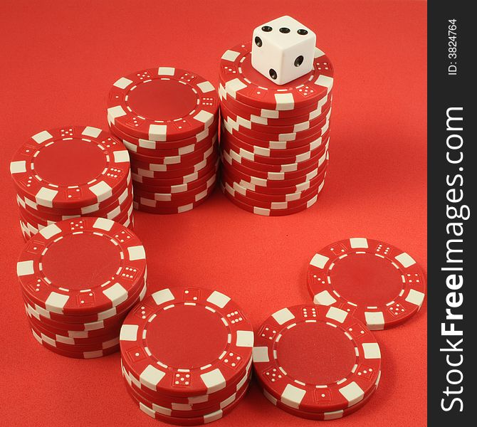 A stair formed by poker chips and a die on the highest step