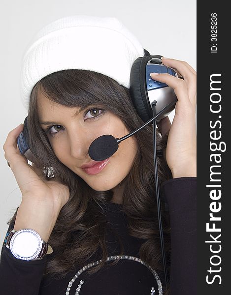 Pretty young woman with headphones and a cap