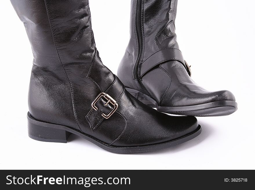 Fashionable leather female boots on a white background