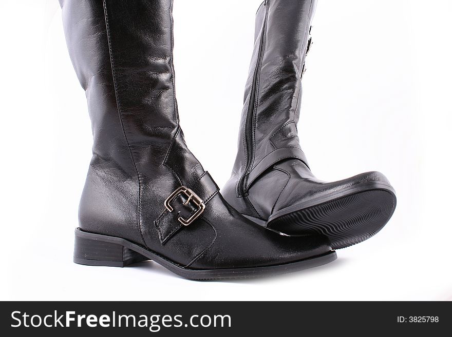 Fashionable leather female boots on a white background