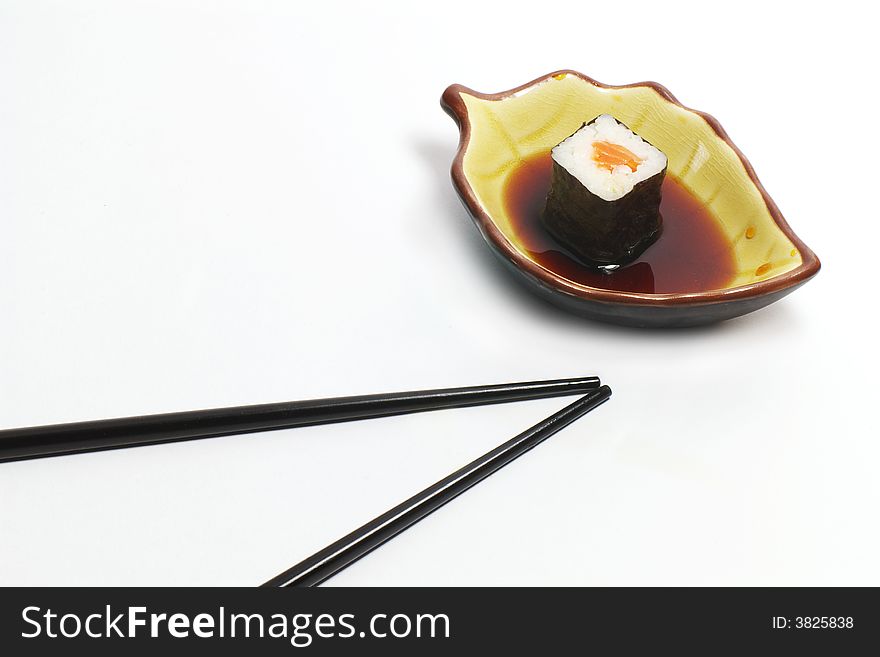 Sushi in a ceramic cup and wood sticks