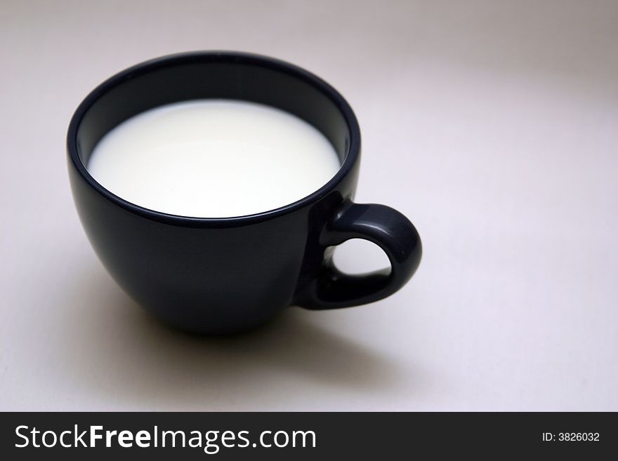 Cup with milk on a white background