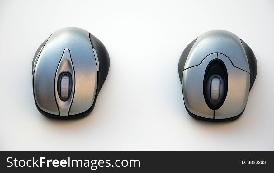 Two silver keyboard computer mice. Two silver keyboard computer mice