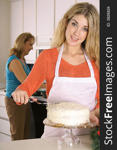 Beautiful woman frosting a cake