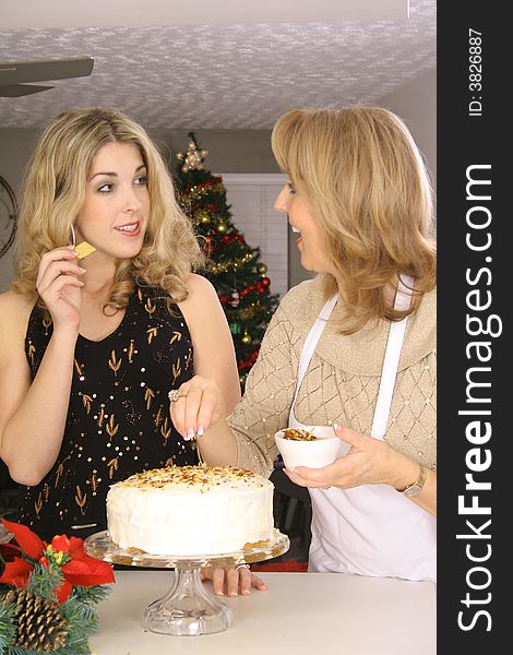 Shot of a mother and daughter talking over cake