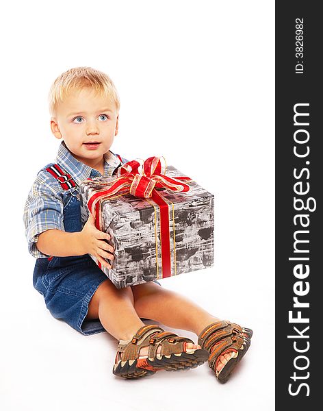 Cute blue-eyed child wiht gift in hands. Cute blue-eyed child wiht gift in hands