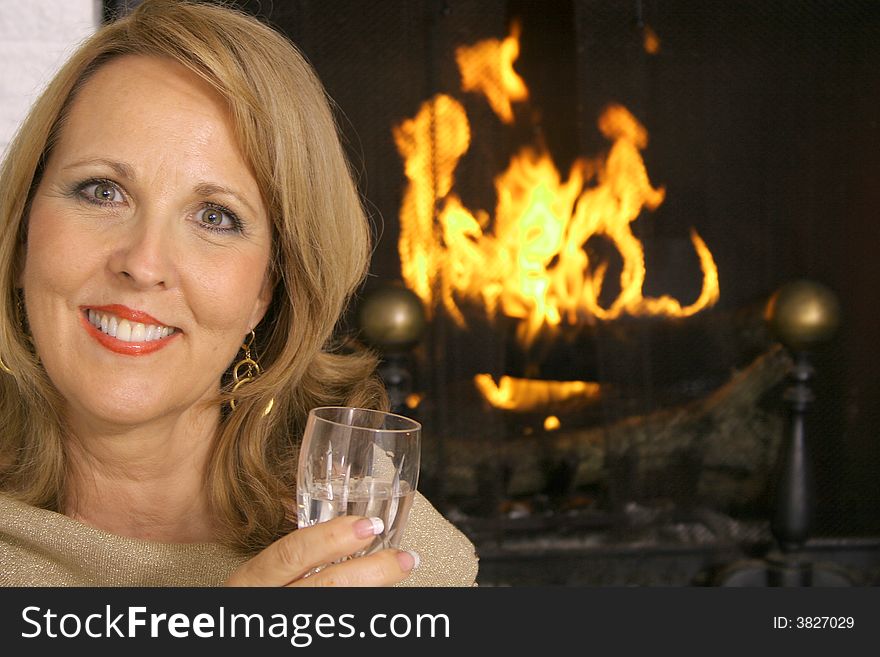 Shot of a stunning woman in front of fireplace