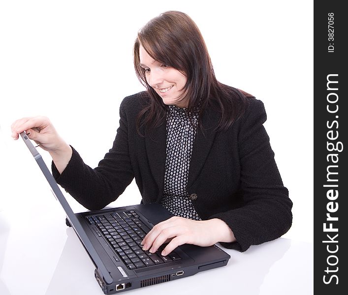 Young woman looks at her laptop isolated on white