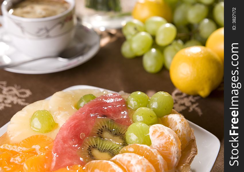 Delicious fruit tarta with coffee