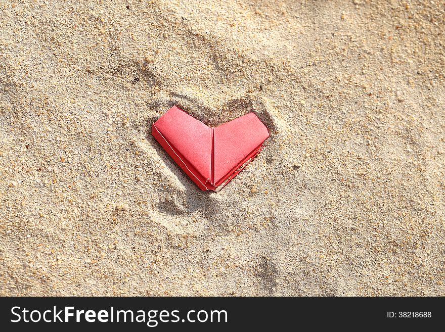 Festive pink paper heart on the beach. Festive pink paper heart on the beach