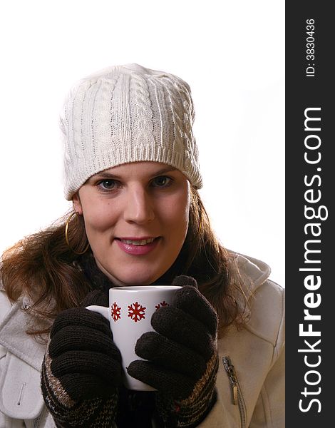 A young woman holding a cup of tea in winterclothes. Isolated over white space (for text). A young woman holding a cup of tea in winterclothes. Isolated over white space (for text).