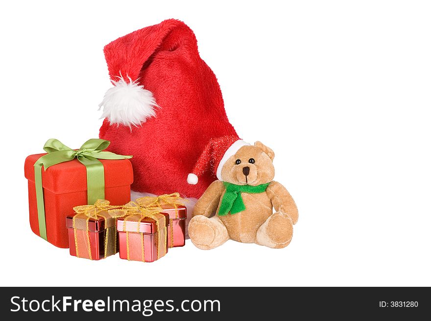 Red gift box with green ribbon, Santa Teddy and Santa hat - isolated over a white background. Red gift box with green ribbon, Santa Teddy and Santa hat - isolated over a white background
