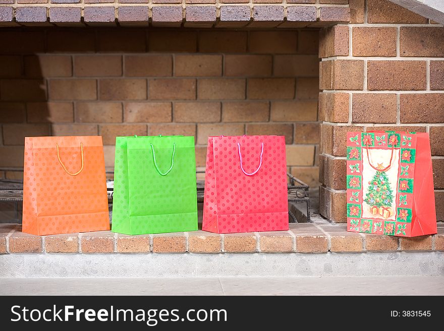 Christmas bags with gifts by the fireplace. Christmas bags with gifts by the fireplace