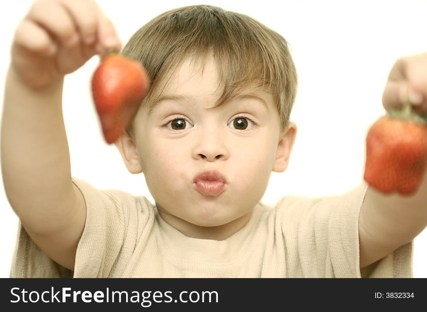 The child holds two berries