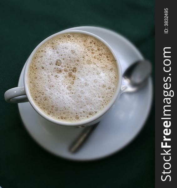 A fresh and hot foamy milk coffee