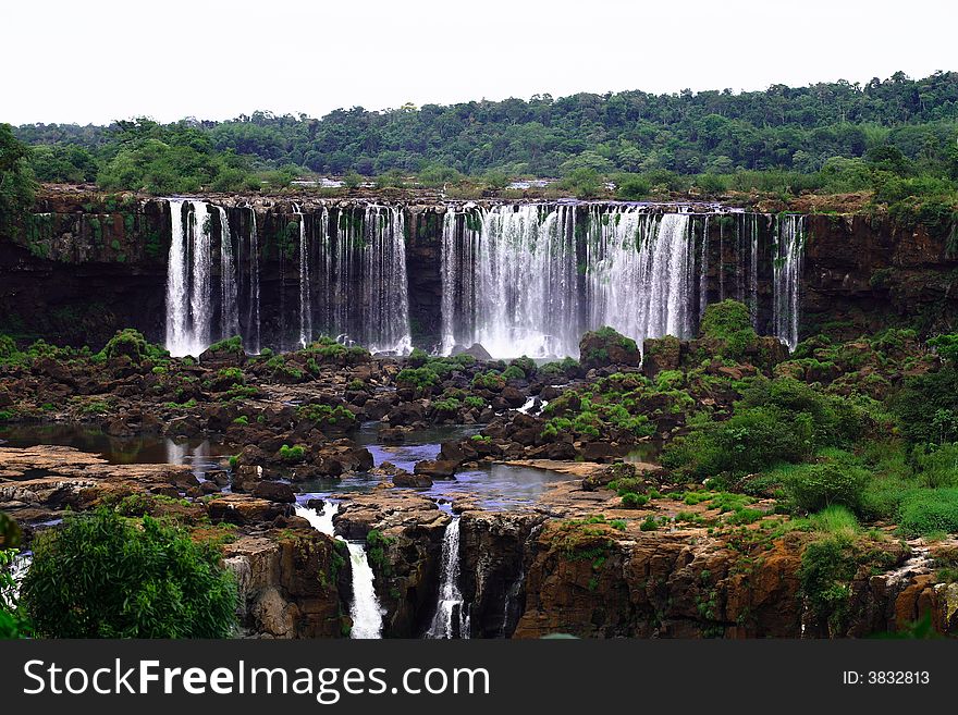 The Iguassu (or Iguazu) Falls is one of the largest masses of fresh water on the planet and divides, in South America, Brazil, Paraguay and Argentina. The waterfall system consists of 275 falls along 2.7 kilometres (1.67 miles) of the Iguazu River. Some of the individual falls are up to 82 metres (269 feet) in height, though the majority are about 64 metres (210 feet). The Iguassu (or Iguazu) Falls is one of the largest masses of fresh water on the planet and divides, in South America, Brazil, Paraguay and Argentina. The waterfall system consists of 275 falls along 2.7 kilometres (1.67 miles) of the Iguazu River. Some of the individual falls are up to 82 metres (269 feet) in height, though the majority are about 64 metres (210 feet).