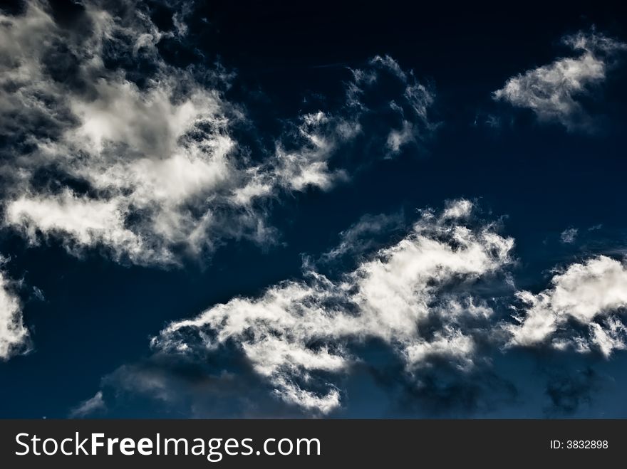A high contrast photograph of the sky filled with clouds. A high contrast photograph of the sky filled with clouds