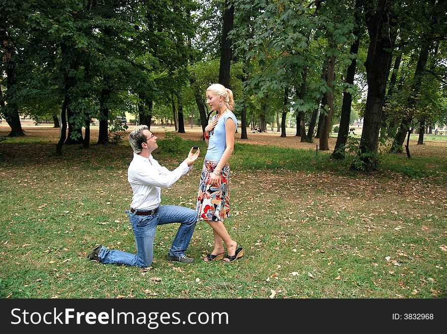 Guy proposing his girlfriend in the park. Guy proposing his girlfriend in the park