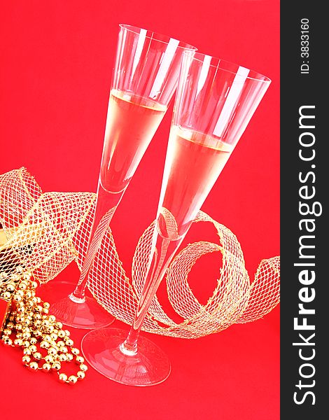 Two glasses of champagne on red background