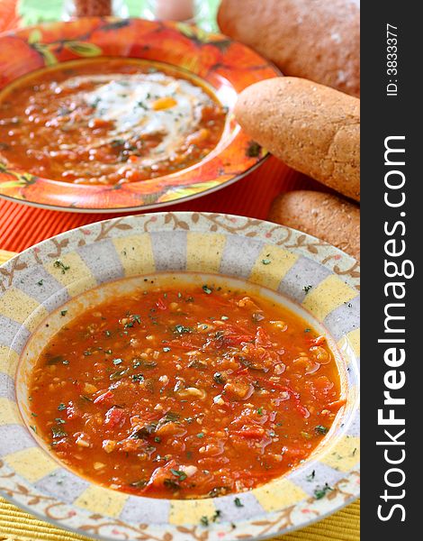 Chunky homemade tomato soup with chopped basil and garlic and a dash of olive oil