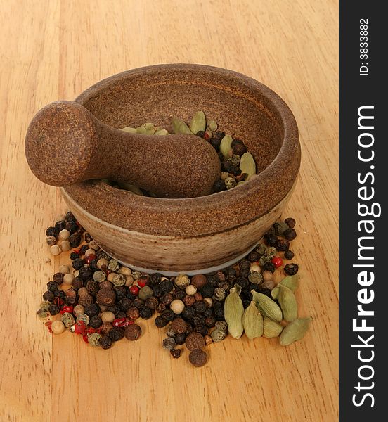 Pestle and mortar with ingredients on wooden board