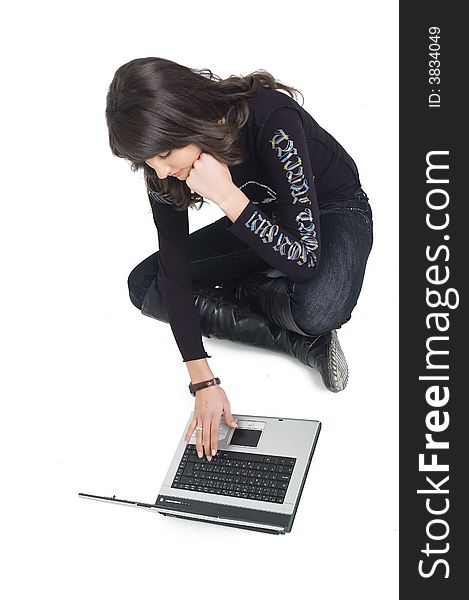 Young brunette girl with lap top computer over white. Modern communications.