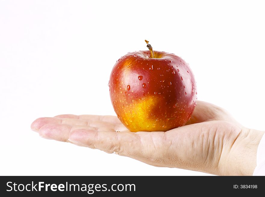 Red apple in a hand of the person