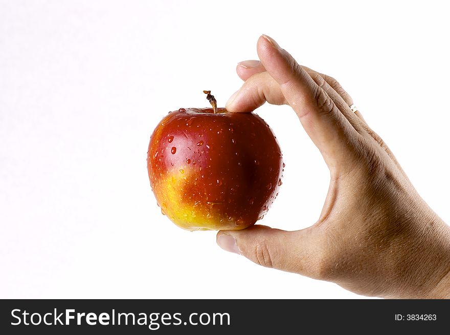 Red apple in a hand of the person