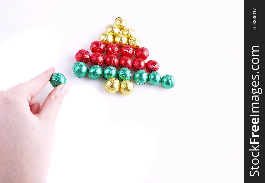 Pralines in the colorful paper/ christmas tree