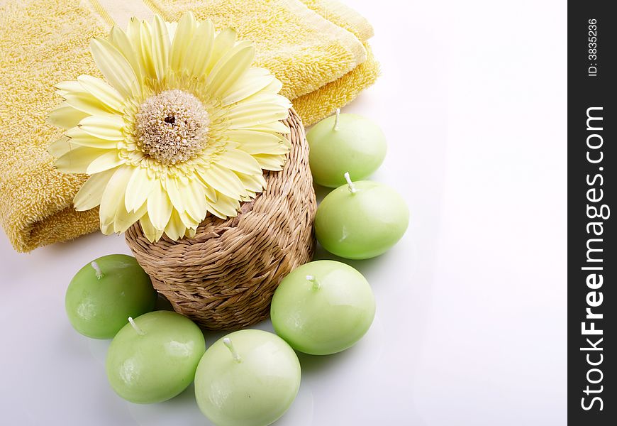 Flower, candle and yellow towel. Flower, candle and yellow towel