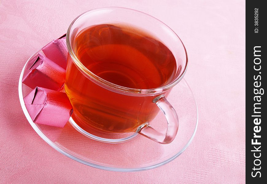Hot tea with chocolate on the pink serviette