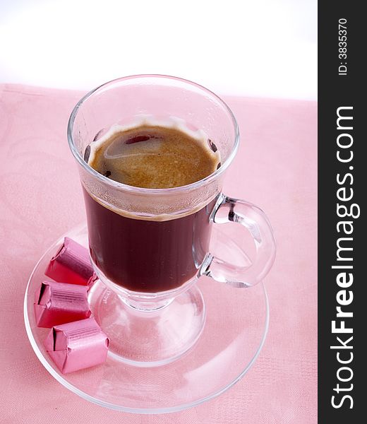 Glass of coffee and chocolate on the pink serviette