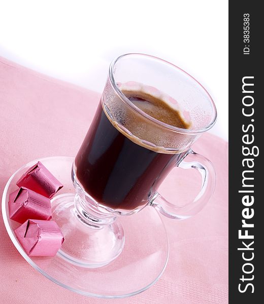 Glass of coffee and chocolate on the pink serviette