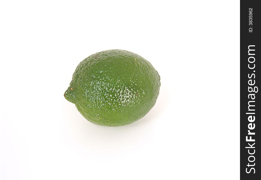 Whole green lime, isolated on white background