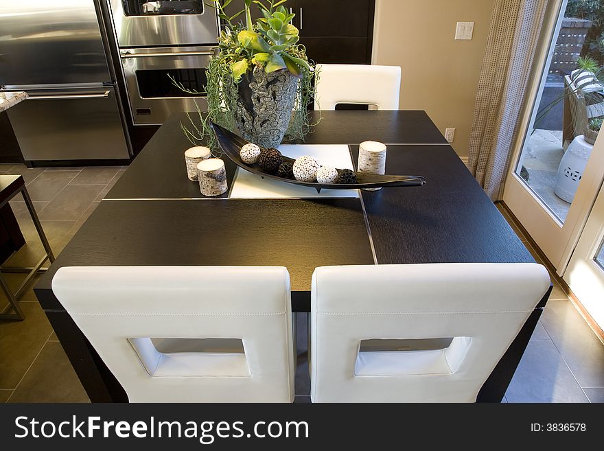 Kitchen and breakfast table with modern chairs. Kitchen and breakfast table with modern chairs.