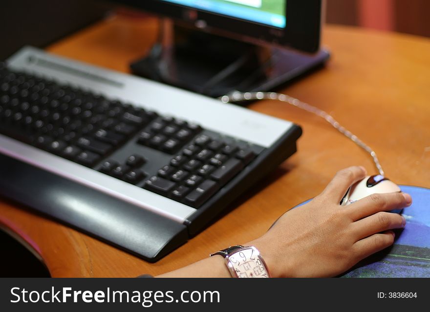 A hand holding mouse to control the computer. A hand holding mouse to control the computer